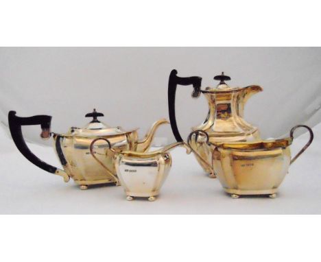 An Edward Viner hallmarked silver four piece teaset of panelled form with ebonised wooden handles to include a teapot, hot wa