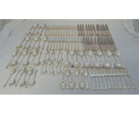 A quantity of silver plated flatware for twelve place settings to include knives, forks, spoons, soup spoons and cake forks