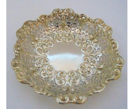 A late Victorian hallmarked silver circular fruit bowl with pierced and scroll chased sides, London 1894, approx total weight