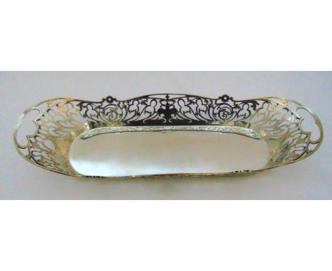 A hallmarked silver shaped oval and pierced roll basket with inset side handles and presentation engraving, Sheffield circa 1