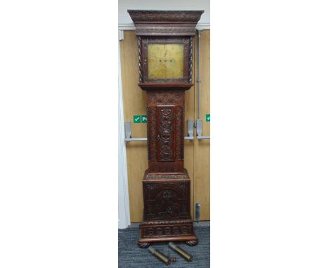 A carved country oak longcase clock with brass dial, Arabic numerals, subsidiary dials, to include pendulum, two weights and 