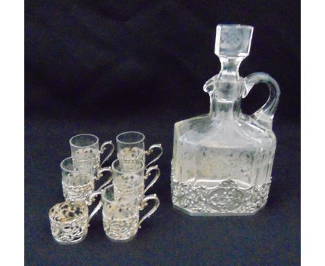 A Dutch etched crystal decanter with drop stopper and pierced silver mounts, and matching silver liqueur glasses, import mark