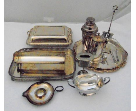 A quantity of silver plate to include a Judaica candle holder, trays, a cocktail shaker, an entrée dish and cover and a coffe