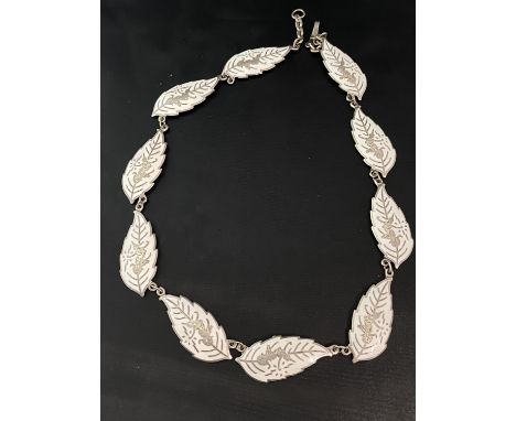 A white metal and enamel necklace 