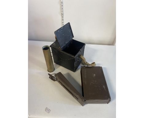 Two military ammunition cases and a brass shell 