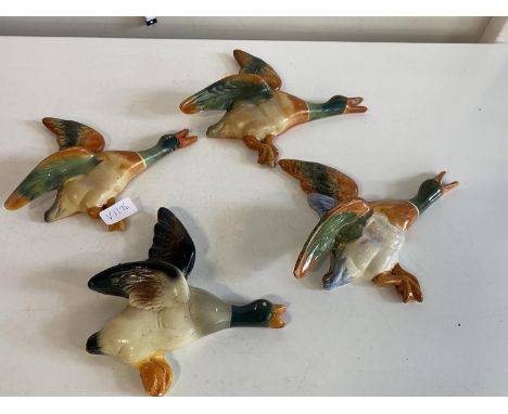 Four assorted ceramic duck wall hanging figurines one with repair, shipping unavailable
