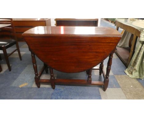 An Oak Gate Legged Drop Leaf Oval Topped Dining Table, 102cm Wide 