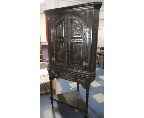 A 19th Century Carved Oak Corner Cabinet on Stand with Pierced Brass Hinges, Carved Arched and Paneled Doors to Shaped Shelf 