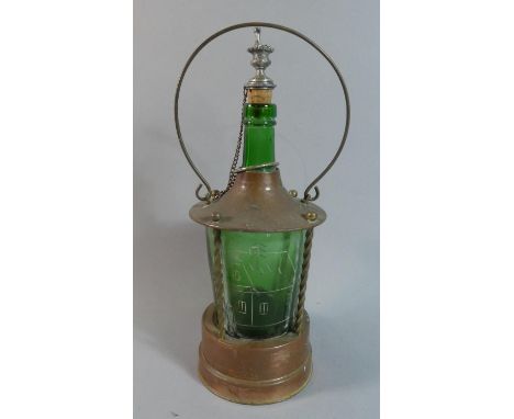 A Continental Musical Novelty Decanter in Copper and Brass Carrier the Green Glass Bottle with Etched House and Trees, Unrela