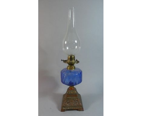 A Late Victorian Oil Lamp with Moulded Iron Base and Blue Glass Reservoir, Total Height 53cm 