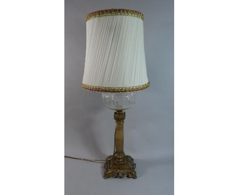 A 19th Century Oil Lamp with Plain Glass Reservoir and Moulded and Pierced Gilt Metal Base, Converted to Electricity with Sha