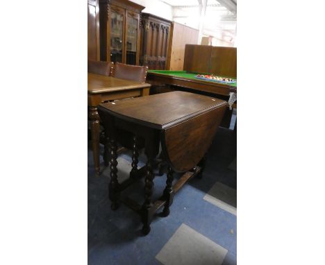 An Oak Barley Twist Gate Legged Drop Leaf Oval Topped Dining Table. 89cm Wide 