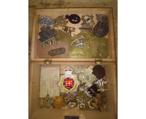 A WWI pair awarded to 493974 PTE. G.A. Wilson Labour Corps together with various cap badges and helmet badges.