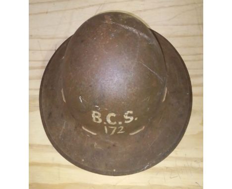 A WWII civilian helmet, painted 'B.S.C. 172' to front, the leather lining stamped 'JRS 1942'.  