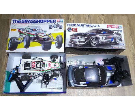 Two Tamiya RC model cars; Grasshopper and Ford Mustang GT4