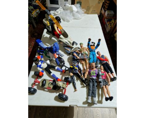 A box of assorted Action Man toys.  