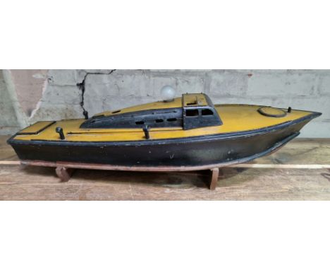 A model wooden boat on stand.Note:- No motor inside