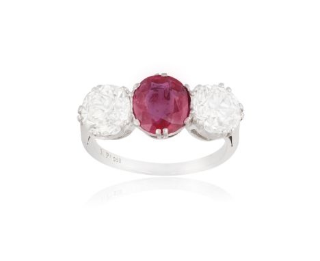 A FINE RUBY AND DIAMOND THREE-STONE RING The oval-shaped ruby, weighing approximately 2.20cts, between old European-cut diamo