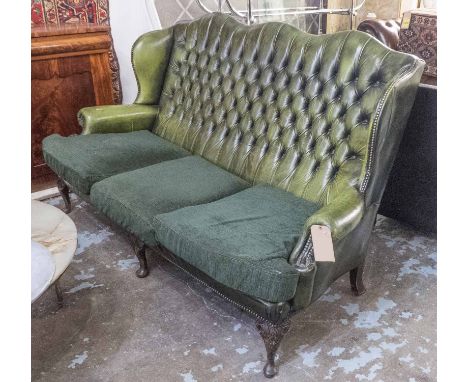 SOFA, Georgian style with deep buttoned green leather upholstery and green fabric seat cushions raised on carved cabriole fro