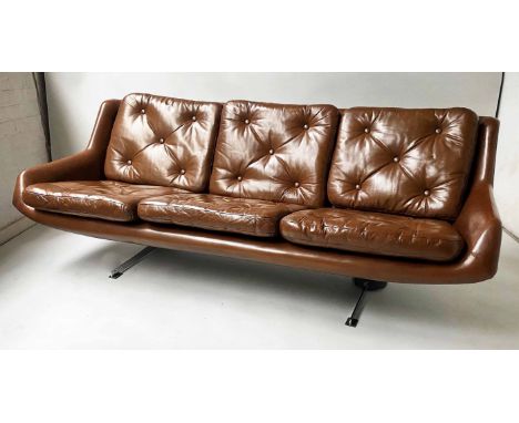 SOFA, three seater, 1970's Danish, mid brown leather upholstered, with six buttoned cushions, on chromed supports, 195cm W.