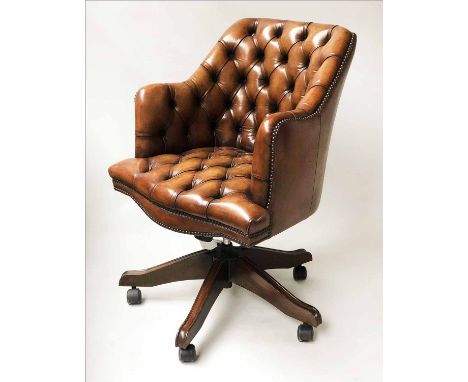 REVOLVING DESK CHAIR, tub form vintage hand dyed brass studded coach leather revolving and reclining on an adjustable base wi