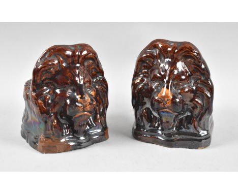 A Pair of Late Victorian Treacle Glazed Stoneware Lion Mask Sash Window Stops, Each 13cm high 
