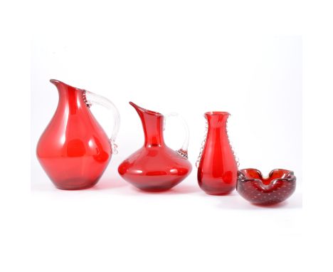 Whitefriars, six ruby and clear glass jugs, various patterns and sizes, a flanged vase, and two lobed dishes (9)