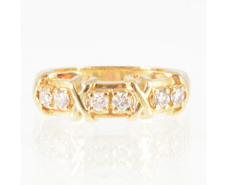 A diamond half hoop ring, six brilliant cut diamonds arranged in pairs and claw set on an all yellow gold band 6.5mm wide at 