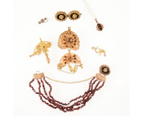 A four strand garnet chip bracelet, fitted with a gold coloured fastener with an oval black onyx seed pearl centre motif, a s