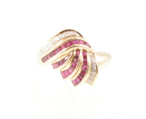 A ruby and diamond dress ring, the square cut rubies and eight cut diamonds fan out from a yellow and white metal domed shape