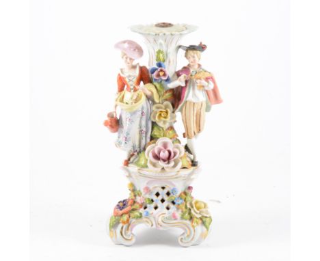 Dresden porcelain candlestick, the column modelled with lady and gentleman in 18th Century dress, floral encrusted and pierce