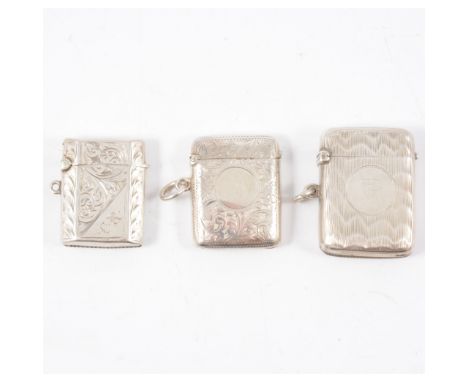 Three silver vesta match cases, one engine turned 40mm, two engraved with scrolls 38mm, all hallmarked Chester - 1902, 1909, 