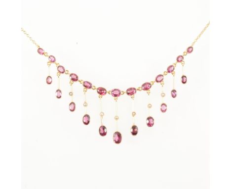 A garnet fringe necklace, thirteen oval faceted garnets graduating in size supporting bar droppers each having a garnet to ba