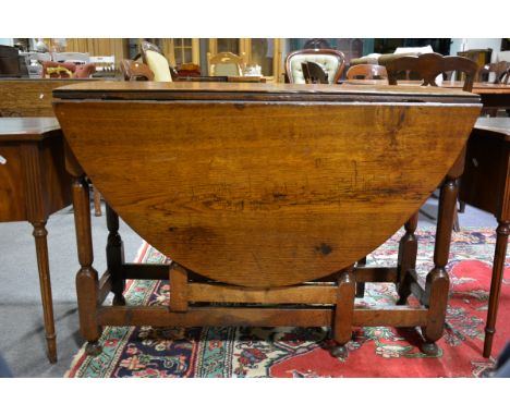 Oak drop leaf table, oval top, turned gate legs, 108cm x 144cm, height 76cm.