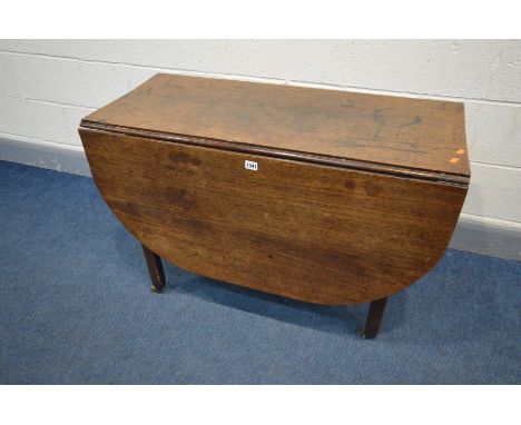 A GEORGIAN OAK OVAL GATE LEG TABLE, on square block legs, brass caps and casters, width 43cm x open width 132 x depth 99cm x 