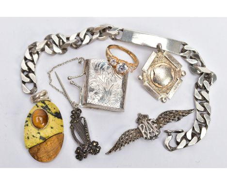 SEVEN ITEMS OF SILVER AND WHITE METAL JEWELLERY, to include a miniature hinged purse, an RAF brooch, a curb link identity bra