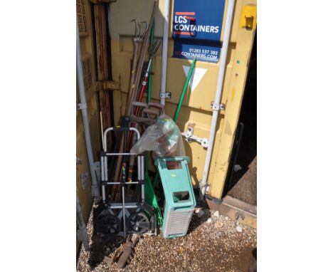 A COLLECTION OF GARDEN TOOLS including forks, spades, hoes, a folding sack truck, an electric strimmer (untested) a cast iron