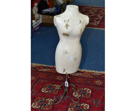 A TABLE TOP MANNEQUIN ON A WROUGHT IRON STAND, the fibreglass mannequin painted white, height 62cm