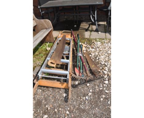 A WOODEN STEP LADDER, an aluminium step ladder and various garden tools