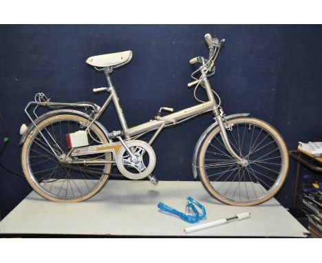 A VINTAGE RALEIGH STOWAWAY FOLDING BIKE with 3 speed Sturmey Archer gears, rear rack, pump and security chain (no key)