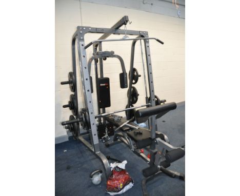 A BODYMAX CF380 SMITH MACHINE MULTI GYM with eighteen weight in pairs from 25kg to 2.5kgs and thirty three 60cm square padded