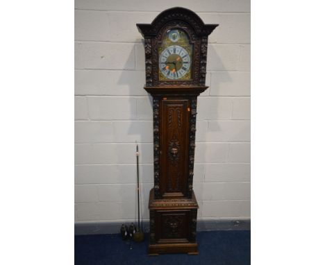 A LATE 19TH/EARLY 20TH CENTURY OAK EIGHT DAY LONGCASE CLOCK, the hood with an arched glazed door enclosing a strike silent di