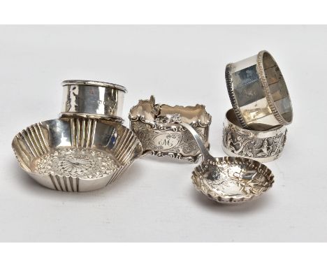 SIX ITEMS OF SILVERWARE, to include four single napkin rings, a decorative trinket bowl and a caddy spoon, the bowl of the sp
