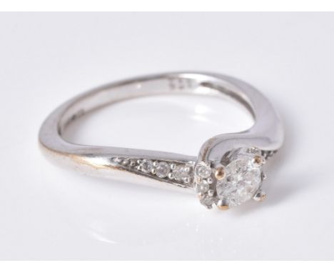 
	
		A diamond single stone ring, the brilliant cut diamond claw set above a brilliant cut diamond mount and diamond three st