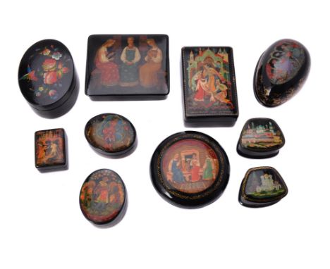 
	
		Nine Soviet Russian painted lacquer boxes, early 1970s, the covers painted with fairytales, two with monasteries and one