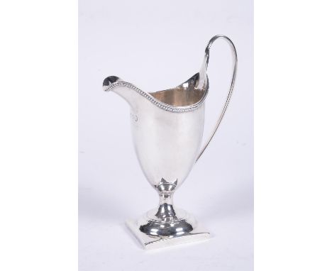 
	
		A George III silver helmet shaped cream jug by Charles Hougham, London 1786, with high clip handle and beaded border, on