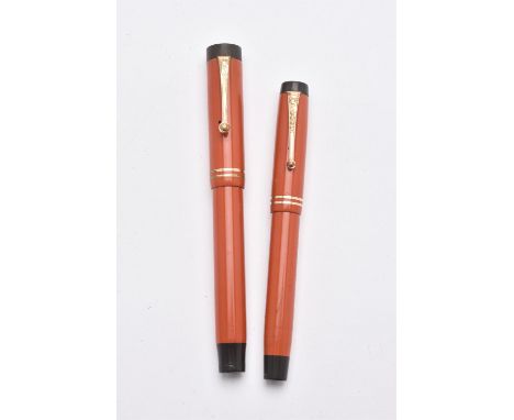 
	
		Parker, Duofold Lucky Curve, an orange fountain pen, the cap with gilt clip and double cap band, piston filling system, 