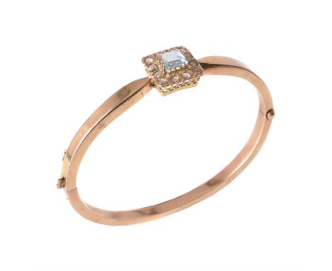 
	
		An aquamarine and diamond hinged bangle, the square cut aquamarine claw set within a surround of rose cut diamonds, on a