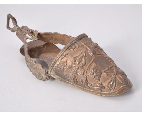 
	
		A South American silver stirrup, unmarked, 19th century, typically chased with flowers and foliage, engraved SC, 22.5cm 