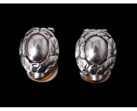 
	
		A pair of Georg Jensen silver 1997 Annual Heritage ear clips, the central polished silver stone in a silver foliate bord